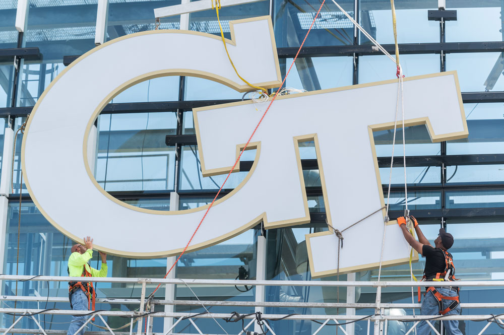Crew installing new GT signage
